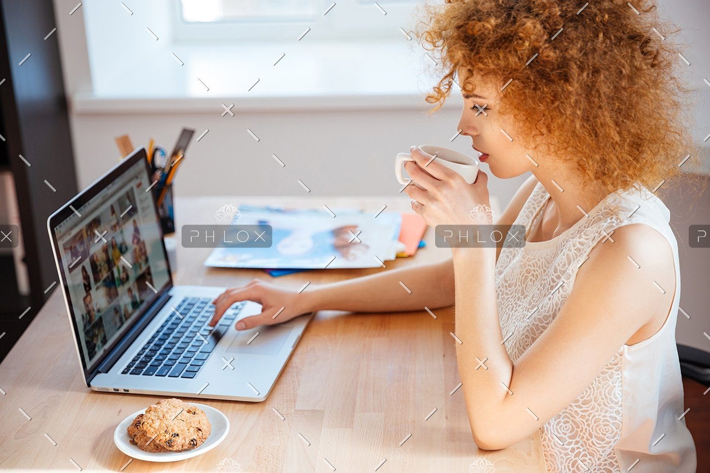 demo-attachment-177-woman-photographer-drinking-coffee-and-working-PJNBP6U